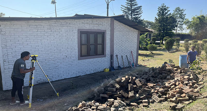 man leveling at a building